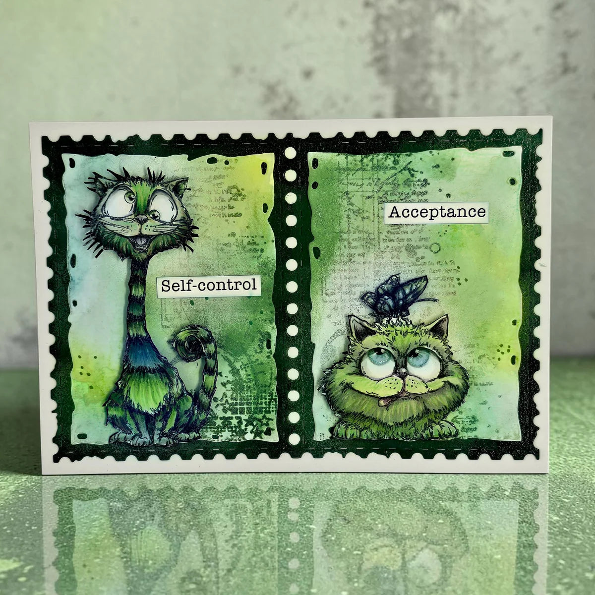 Two green cartoon cats on a postage stamp-style card with text 'Self-control' and 'Acceptance'.