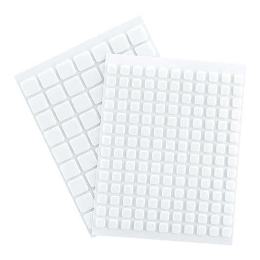 Two sheets of white square stickers on a white background