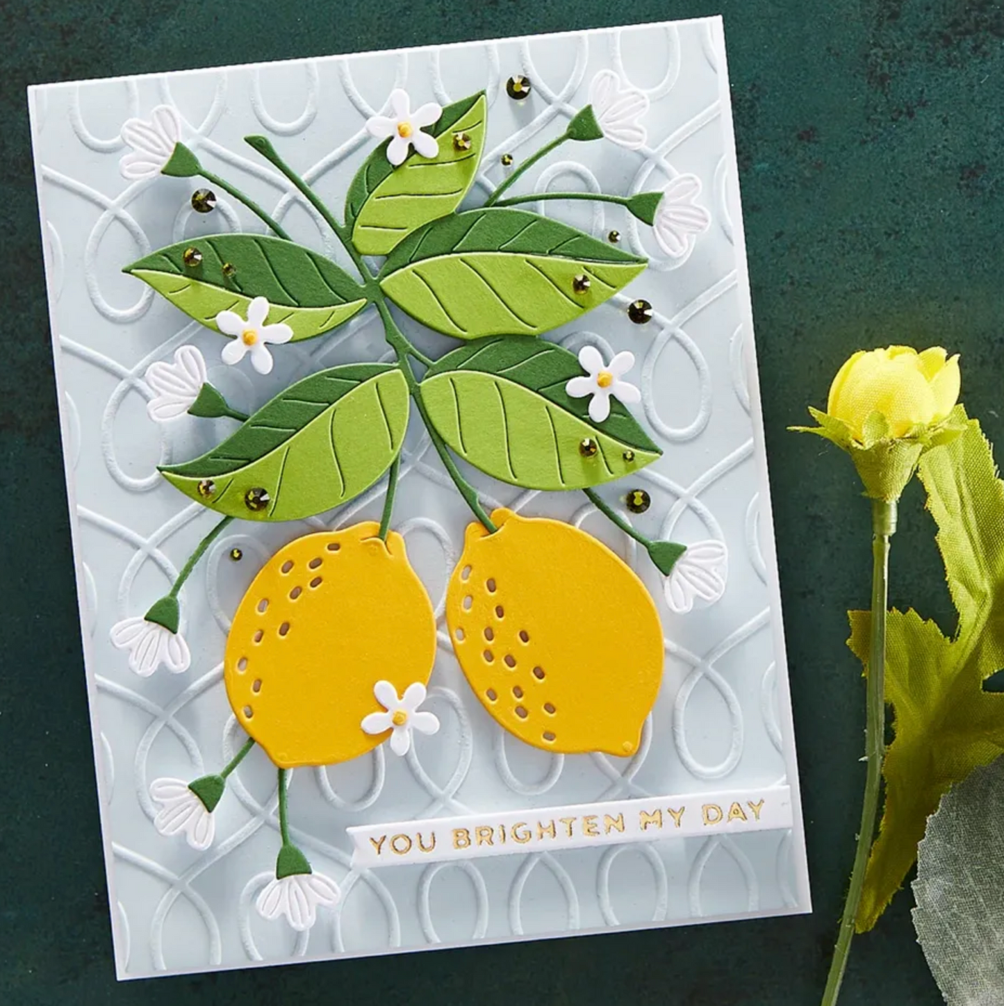 Card with lemon and leaf design on a dark green background