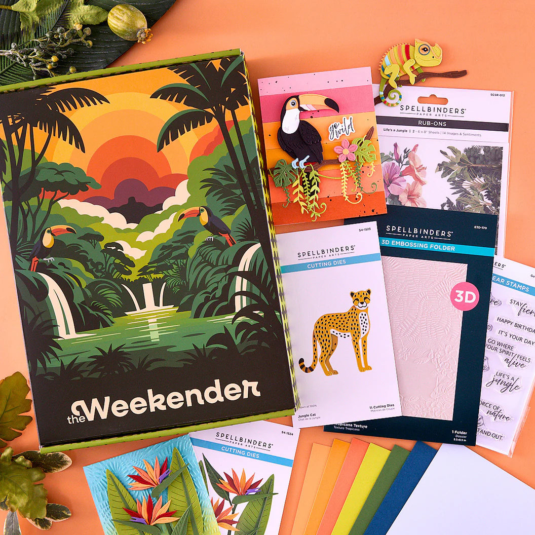 Collection of craft supplies including 'the Weekender' book and embossing folders on an orange surface.
