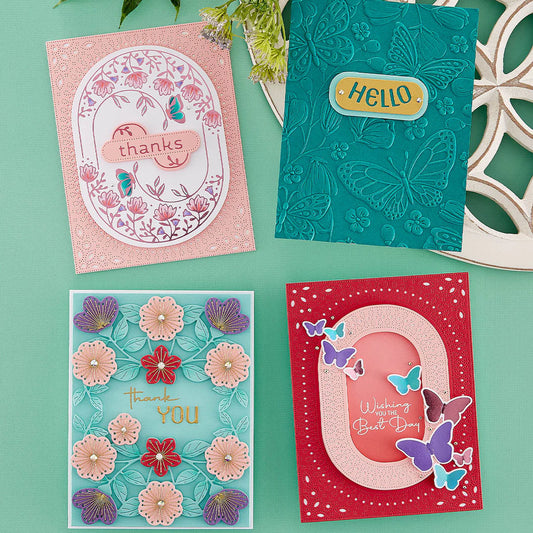 Four greeting cards with oval floral and butterfly designs on a green background