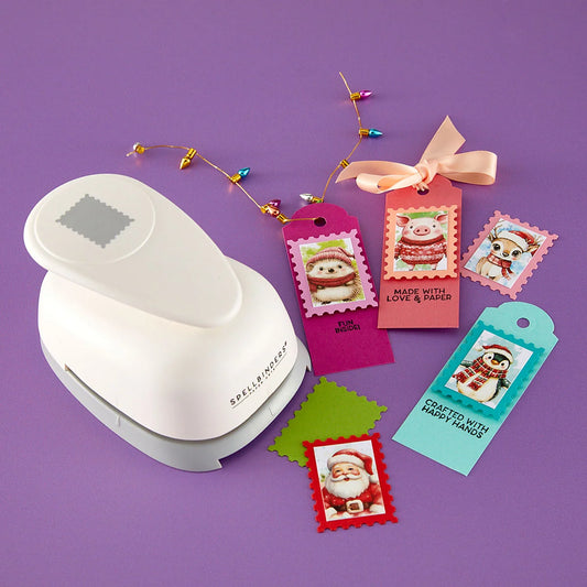 A white die-cut sticker punch tool on a purple background, shown with several colorful stamped and punched holiday gift tags featuring Santa Claus and penguins.