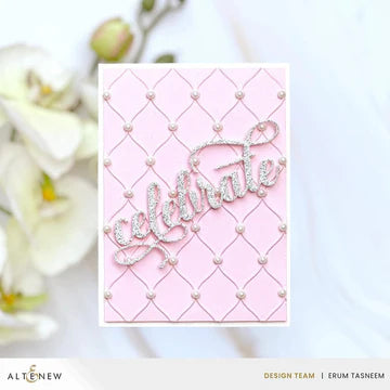Pink card with 'Celebrate' text and decorative elements on a blurred tufted background