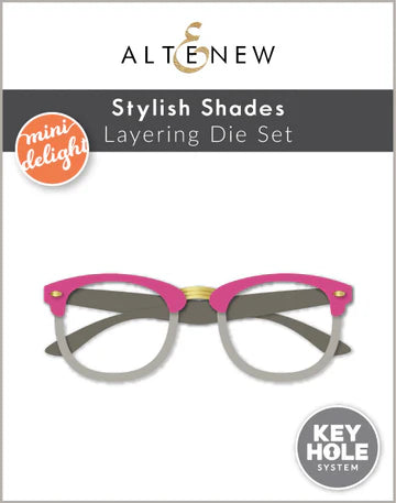 Stylish Shades Layering Die Set packaging with pink and gray eyeglasses design on a white background.