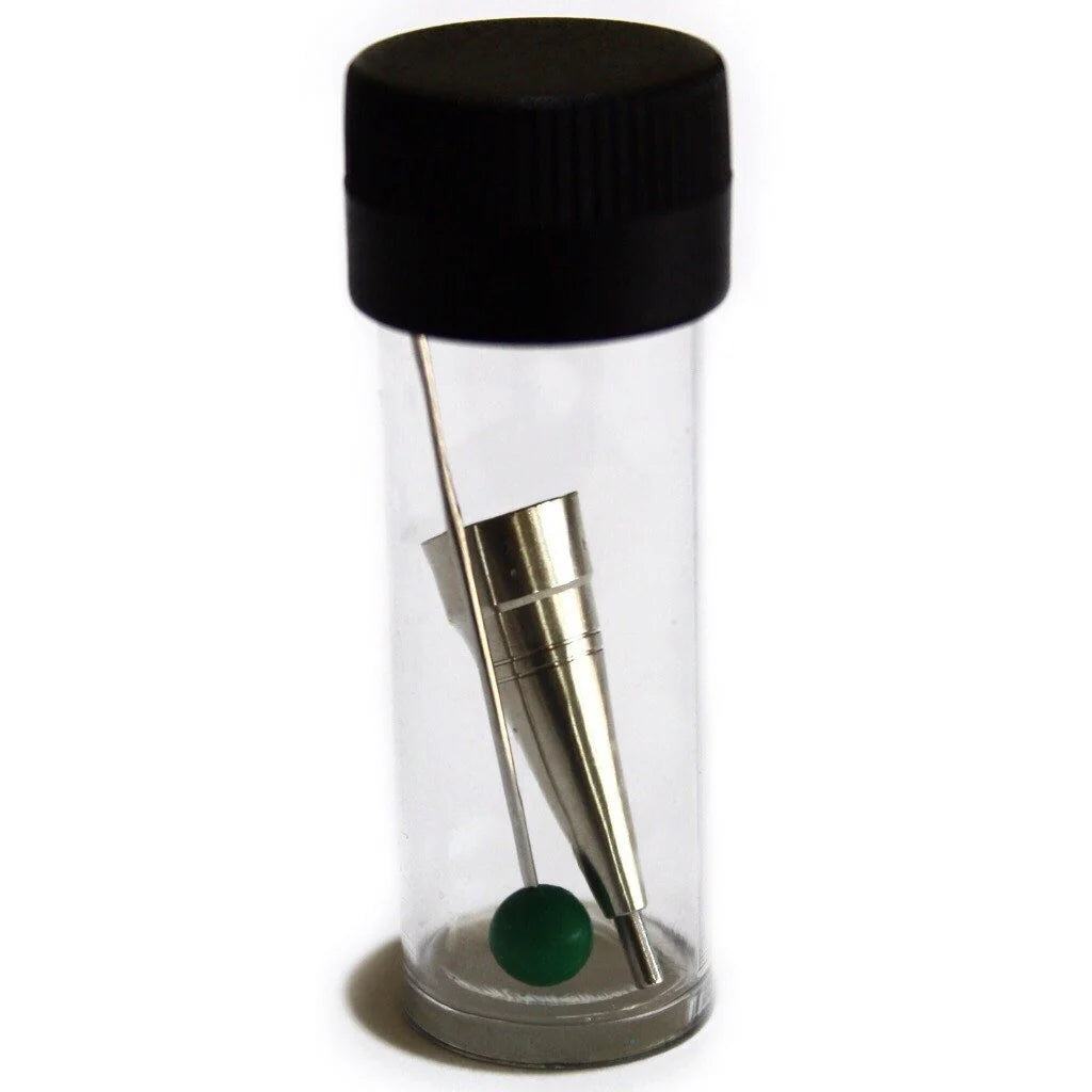 Clear cylindrical container with black lid, gold tool, and green ball on a white background