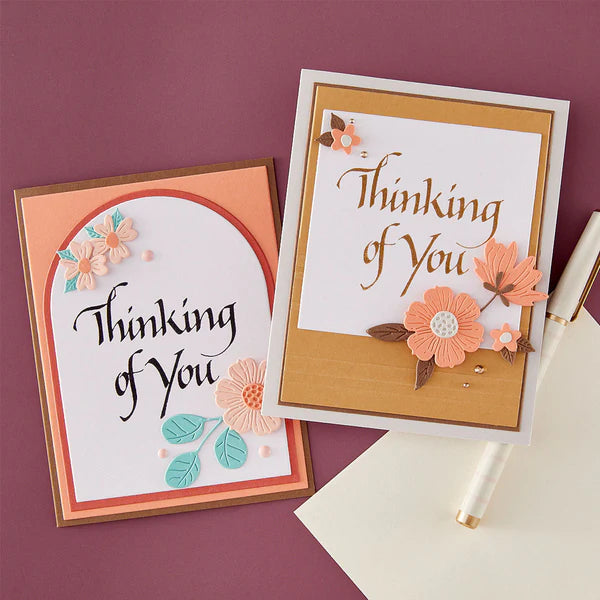 Two 'Thinking of You' cards with floral designs on a purple background
