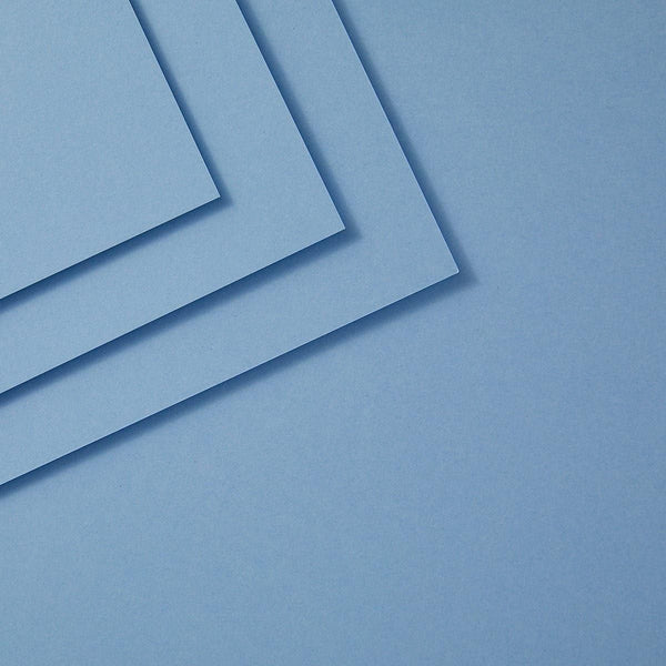 Three sheets of cascade blue paper stacked on a blue background
