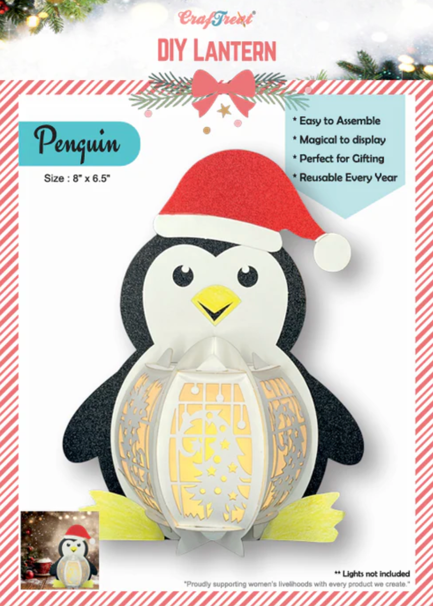 Penguin DIY lantern kit with a Santa hat on a white background