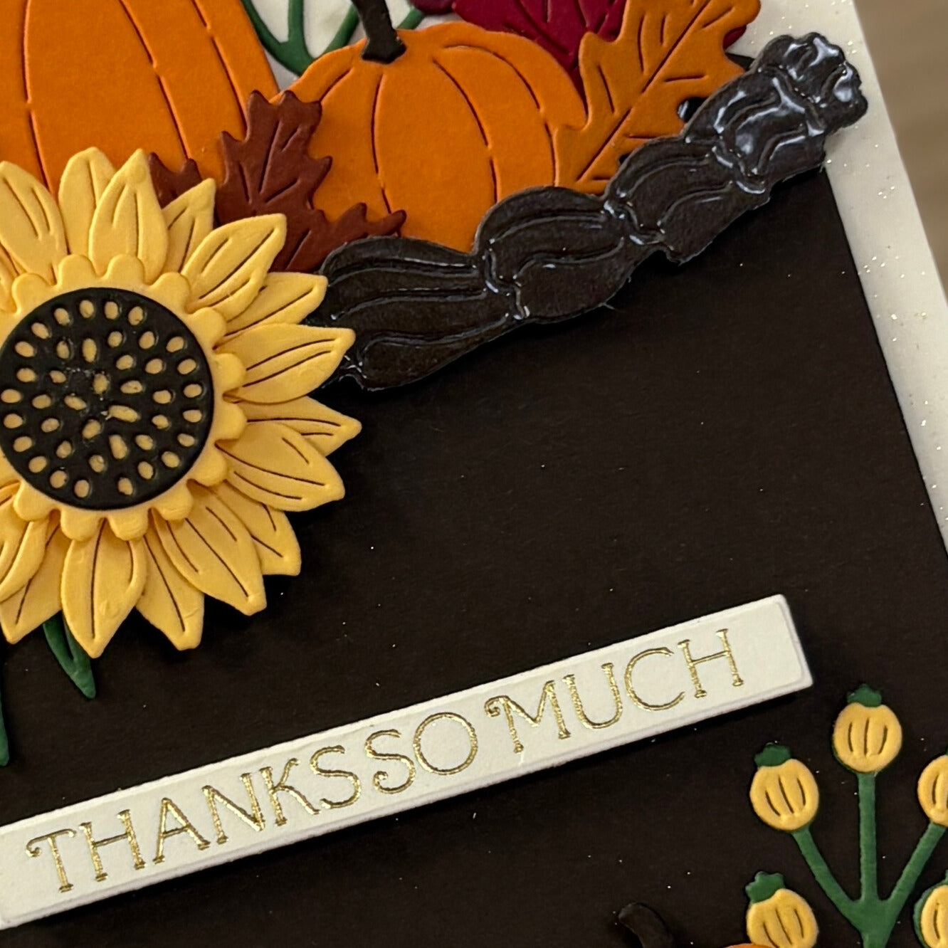Decorative elements with sunflower, pumpkins, and 'THANKS SO MUCH' text on a dark background