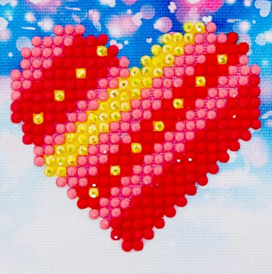 Heart-shaped design made of small beads on a blue background