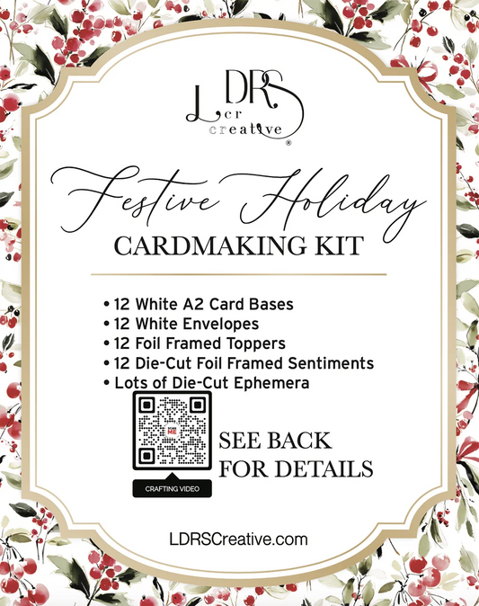 Festive Holiday Cardmaking Kit by LDRS Creative, featuring a white cardmaking kit with 12 white A2 card bases, envelopes, foil frames, and die-cut sentiments, surrounded by a red berry and green leaf floral border. The image includes a QR code and text stating 'SEE BACK FOR DETAILS'.