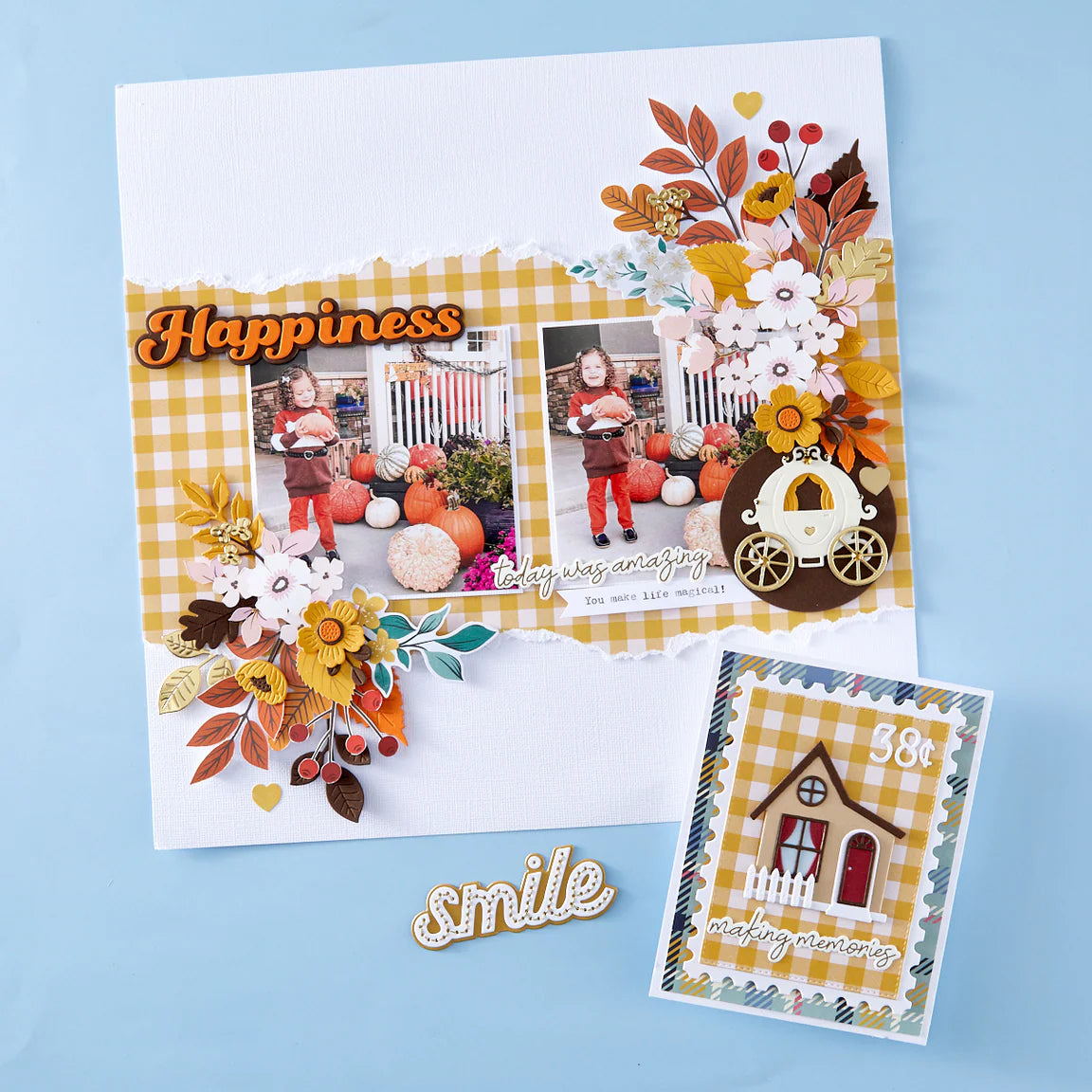 Scrapbook layout with autumn-themed elements, photos, and decorative items on a blue background.