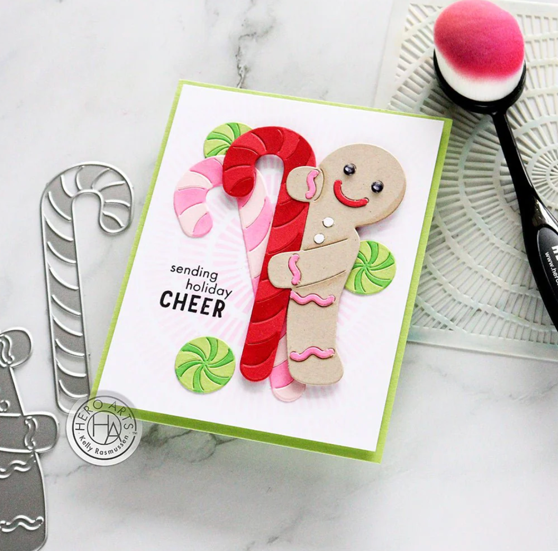 Holiday card with gingerbread man and candy cane design on a marble surface