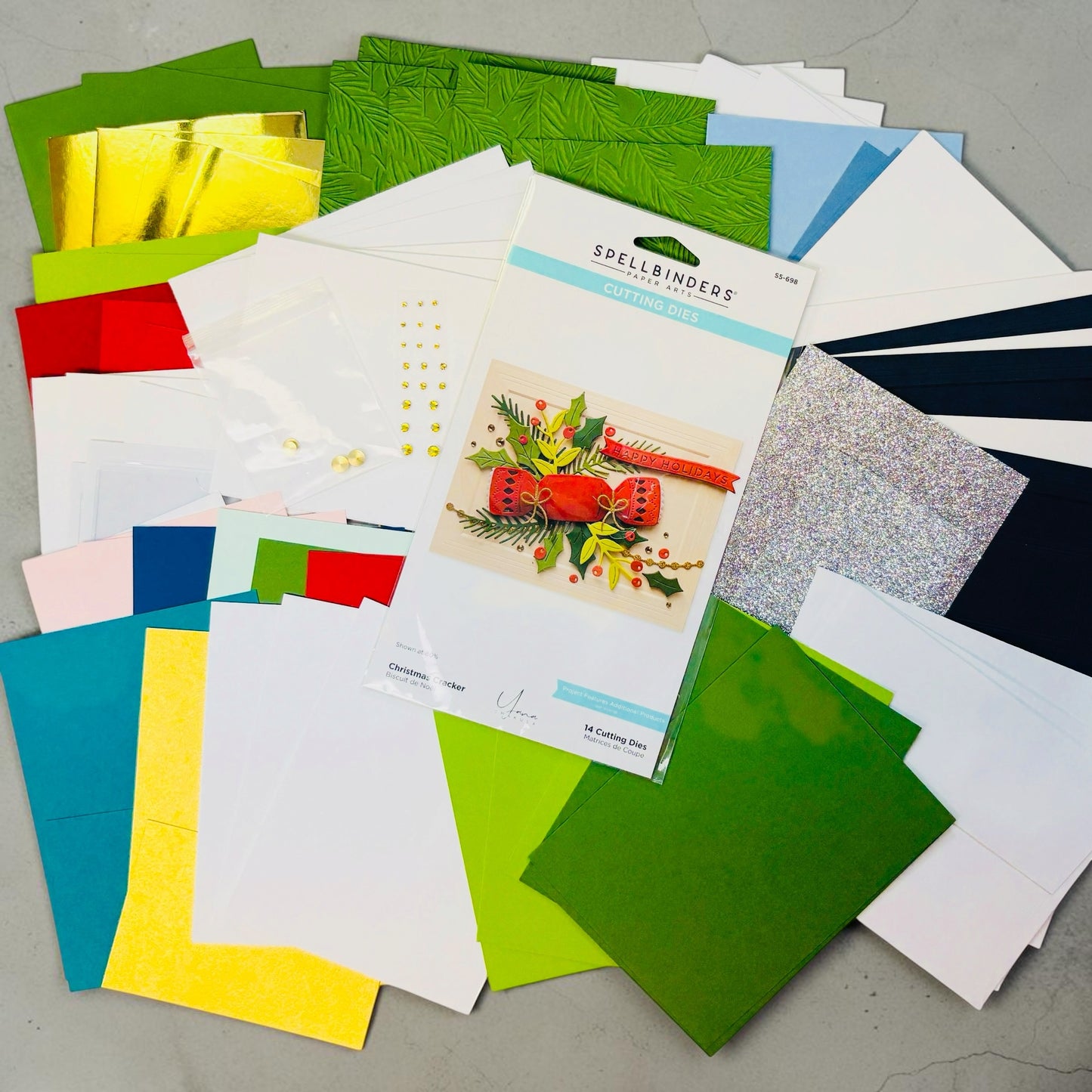 Collection of colorful greeting cards and envelopes on a gray surface