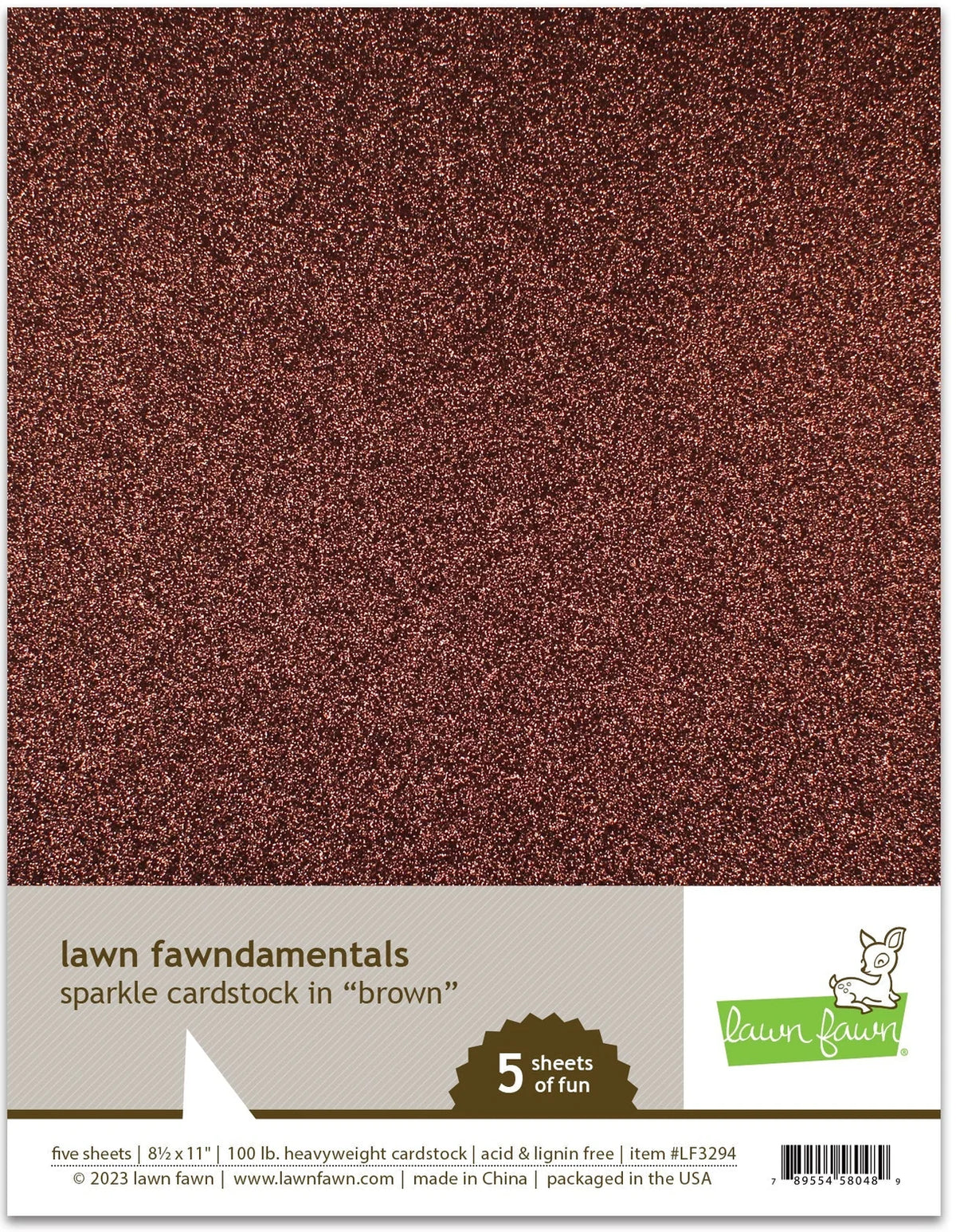 A package of Lawn Fawndamentals sparkle cardstock in brown, showing a close-up of the glittery brown cardstock texture and a white label band with product details and the Lawn Lawn logo.