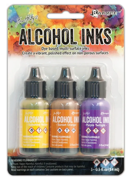 Packaging of Tim Holtz Alcohol Inks with three bottles on a colorful background