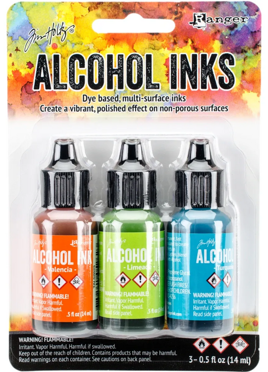 Packaging of Tim Holtz Alcohol Inks with three bottles on a colorful background