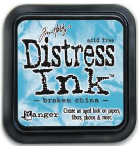 Distress Ink pad by Ranger with 'broken china' color on a blue background