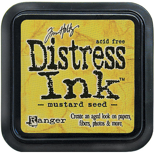 Tim Holtz Distress Ink Pad in mustard seed color with the brand and product name displayed on the label.