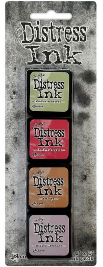 Set of Distress Ink pads with packaging on a textured gray background