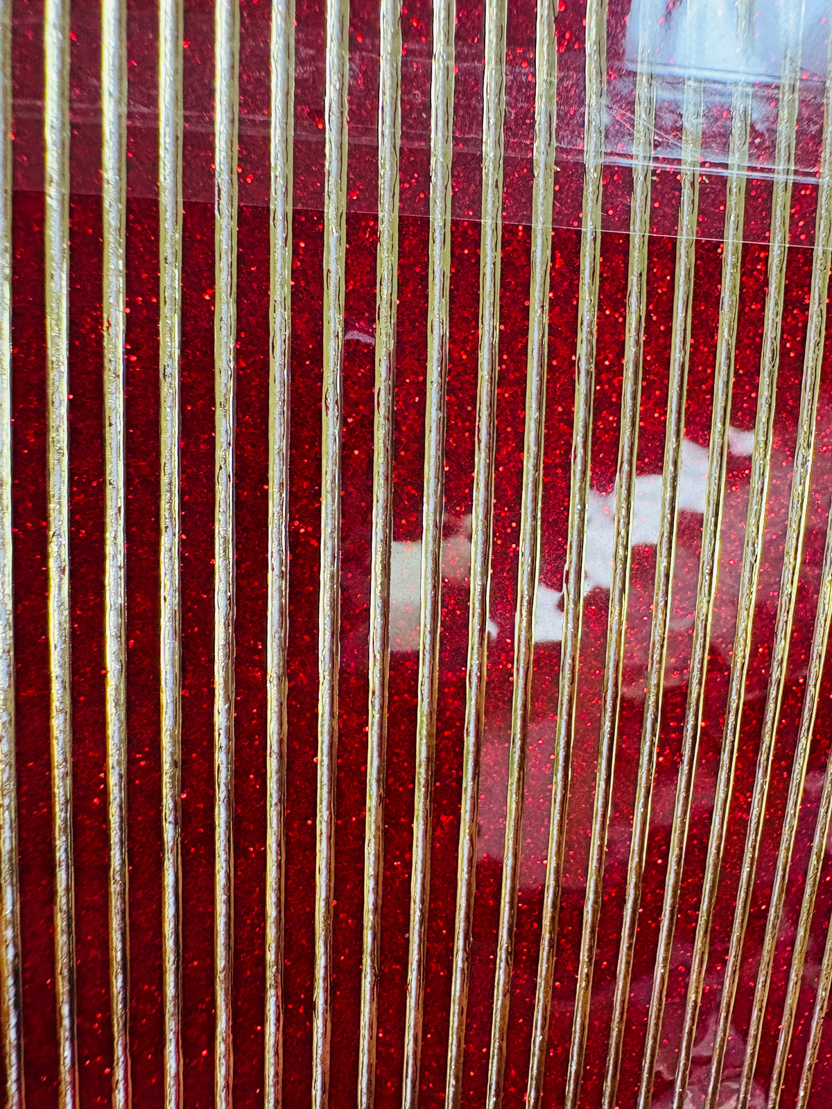 Close-up of red and gold striped sticker