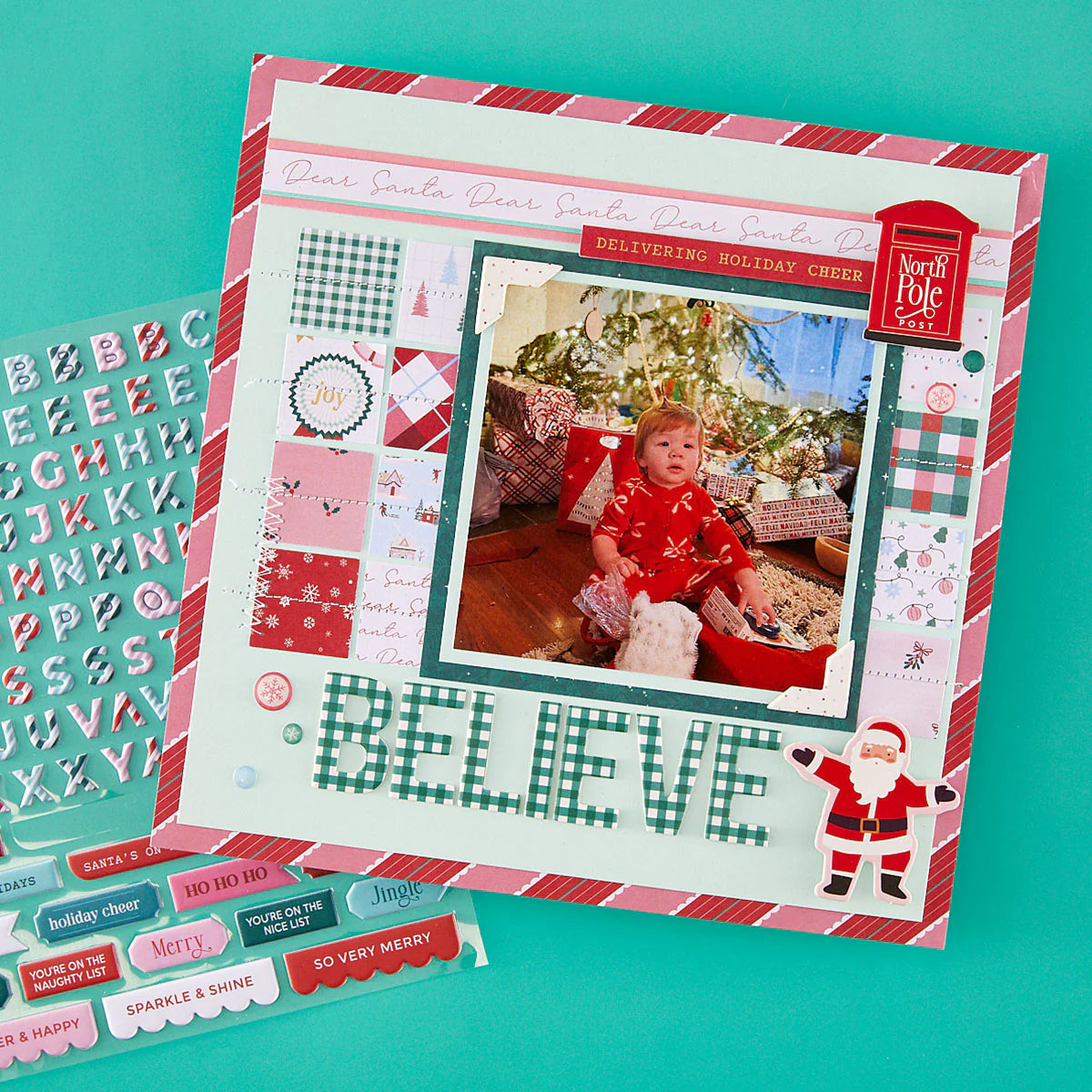 christmas themed scrapbook page with alphabet puffy stickers a baby and big word believe with santa clause
