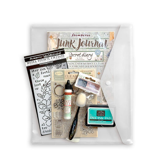 Secret diary junk journal with stencil, matt glue, stamp, blending brush, and turquoise ink pad on white background