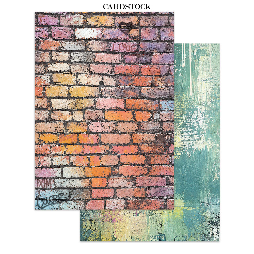 Two sheets of cardstock with printed artwork on a white background. The larger sheet shows a distressed multicolor brick wall with graffiti-style text and a small heart; the smaller sheet shows an abstract teal, green, yellow, and white painted texture.