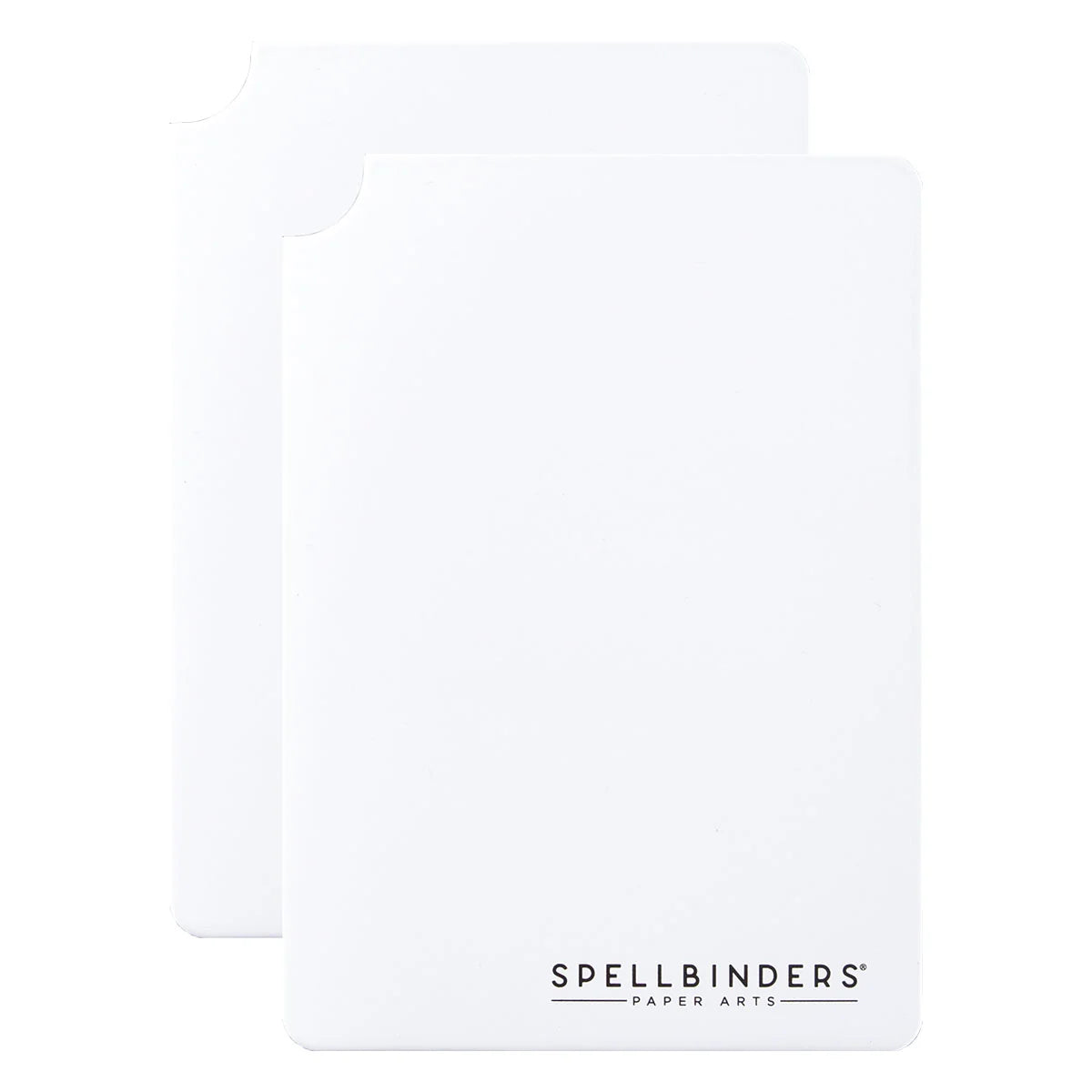 Two white Spellbinders Paper Arts binding mats, with the front mat showing the black Spellbinders logo at the bottom, set against a plain white background.