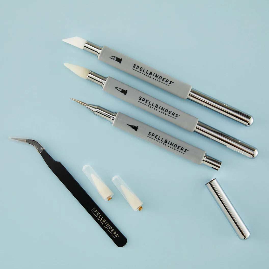 Set of Spellbinders craft tools on a light blue background