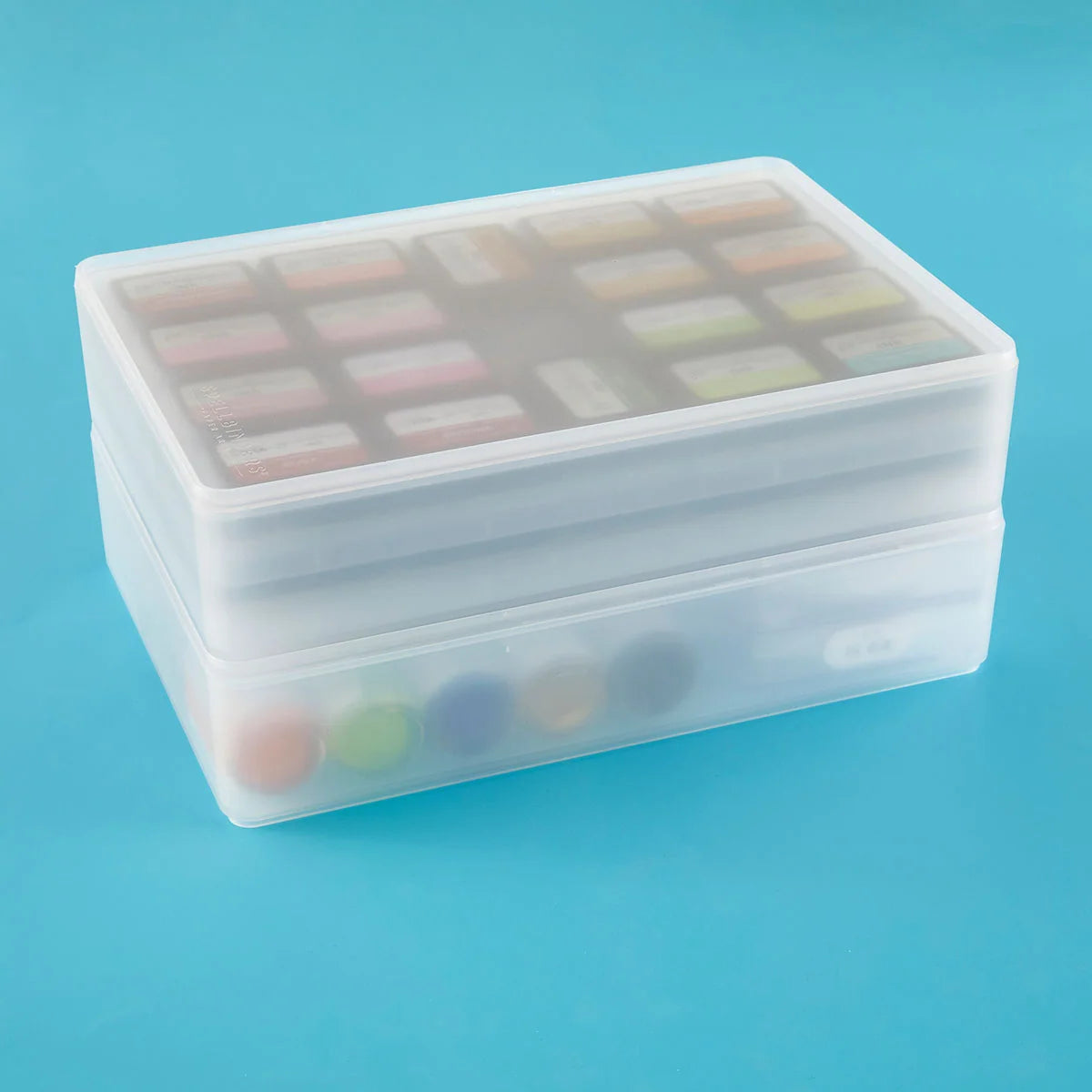 Transparent plastic container with colorful items on a blue background