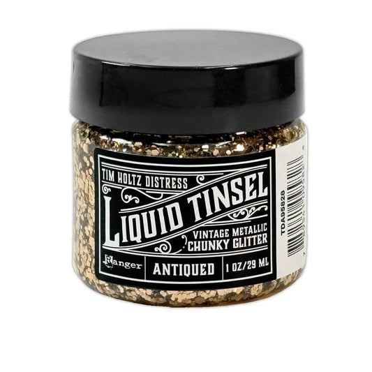 A 1 oz jar of Tim Holtz Distress Liquid Tinsel Antique Vintage Metallic Chunky Glitter by Ranger, featuring a black lid and a black-and-white label, set against a plain white background.
