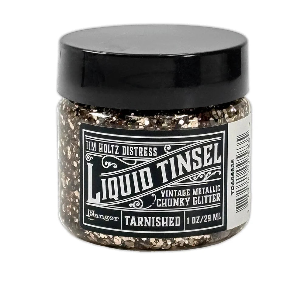 A jar of Tim Holtz Distress Liquid Tinsel Vintage Metallic Chunky Glitter in the Tarnished shade, featuring a black lid and a black-and-white label, set against a plain white background.