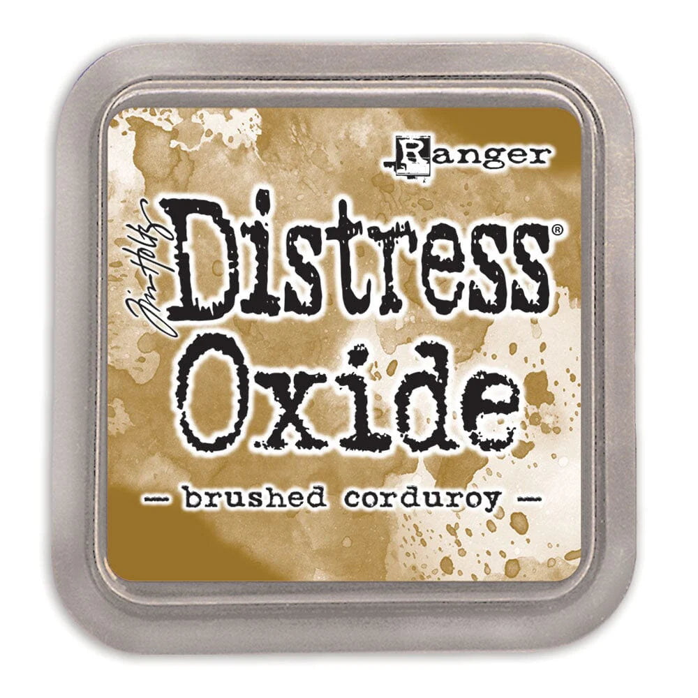 Ranger Distress Oxide ink pad with 'brushed corduroy' color on a beige background