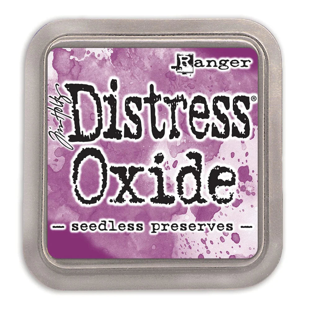 Distress Oxide ink pad by Ranger with a purple watercolor background