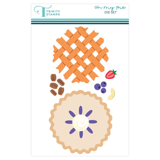 Trinity Stamps 'Oh My Pie Die Set' featuring illustrated pie designs, including a lattice-top pie, a fluted pie base with a purple flower center, pecans, blueberries, a strawberry, and a peach slice, on a white card with the brand logo at the top.