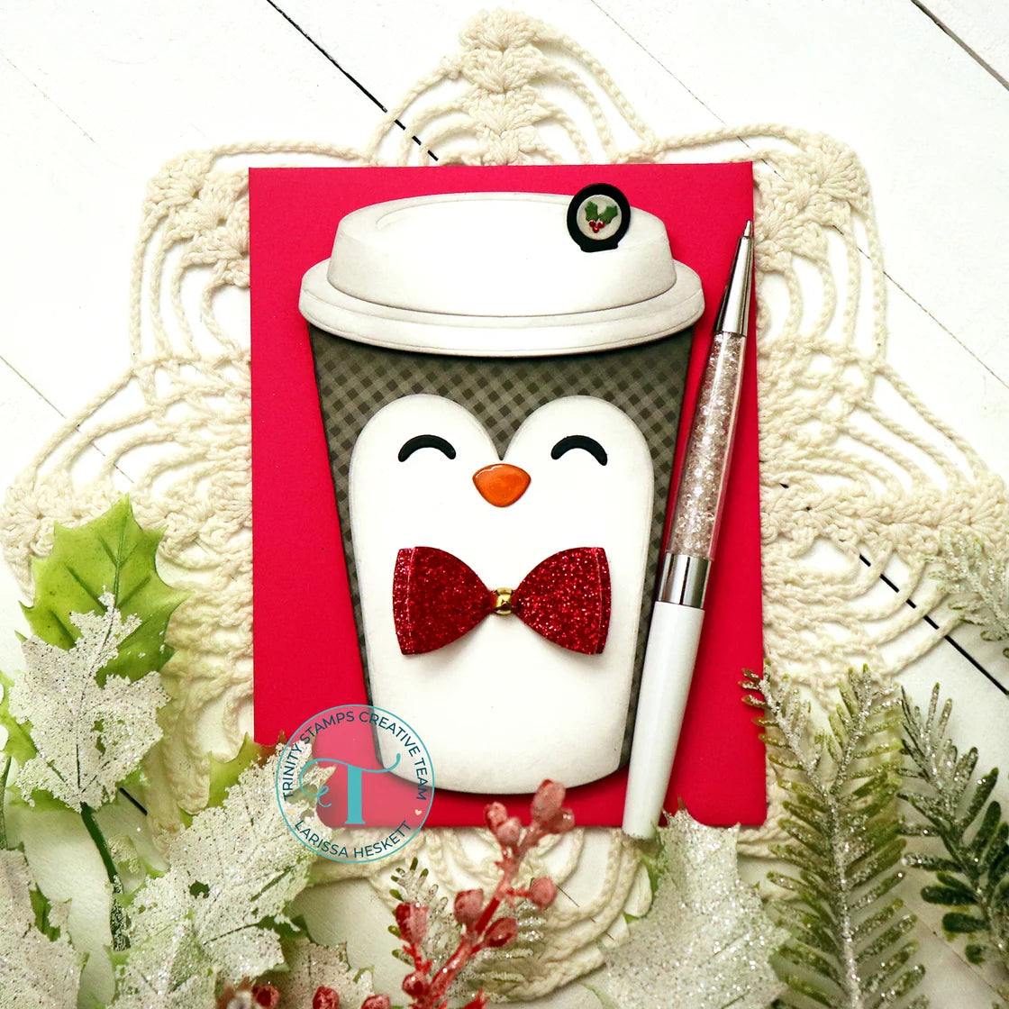 hot paper cup shaped card with a cute holiday penguin on top of a red card panel on a lace doily over a wooden background