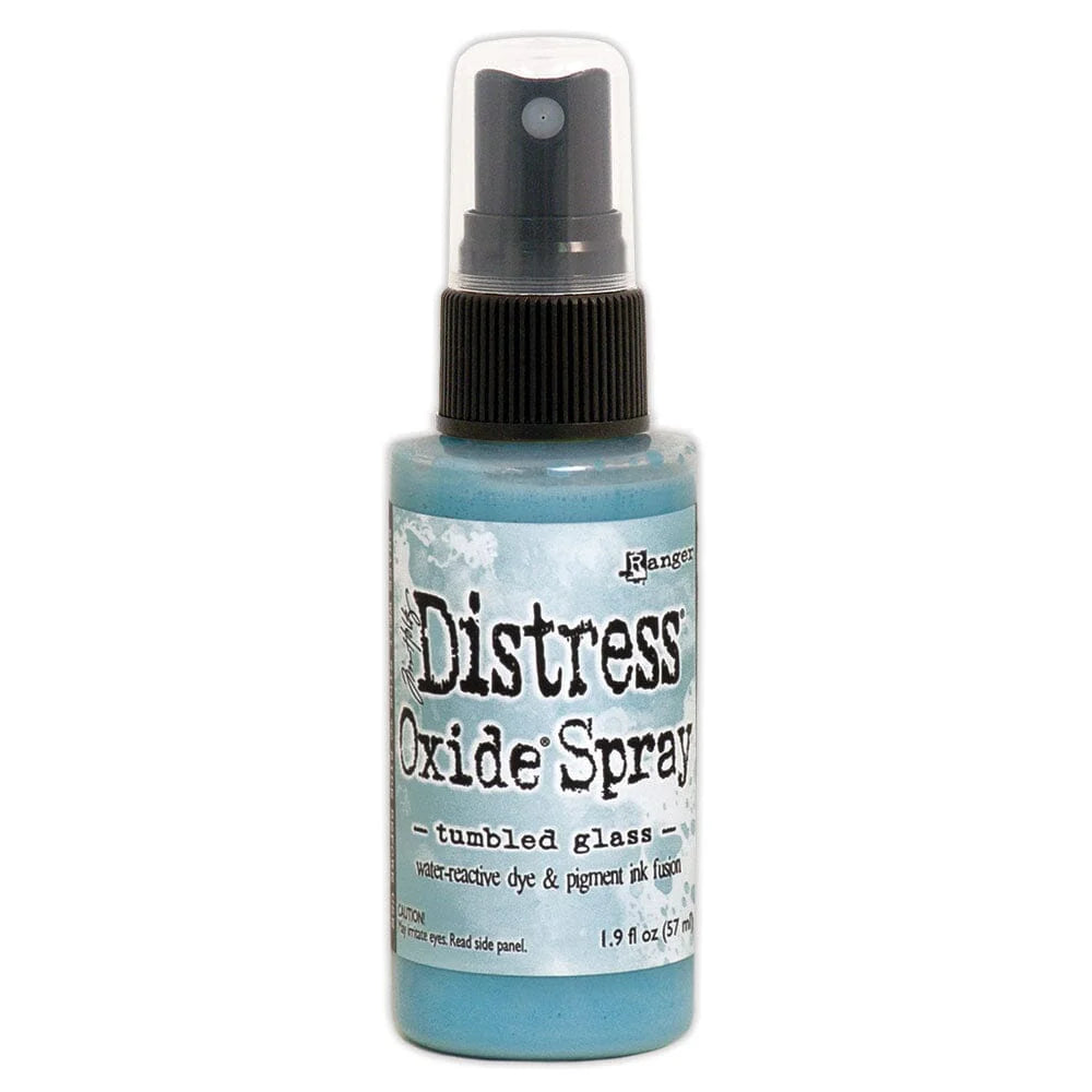 Bottle of Tim Holtz Distress Oxide Spray in tumbled glass color on a white background