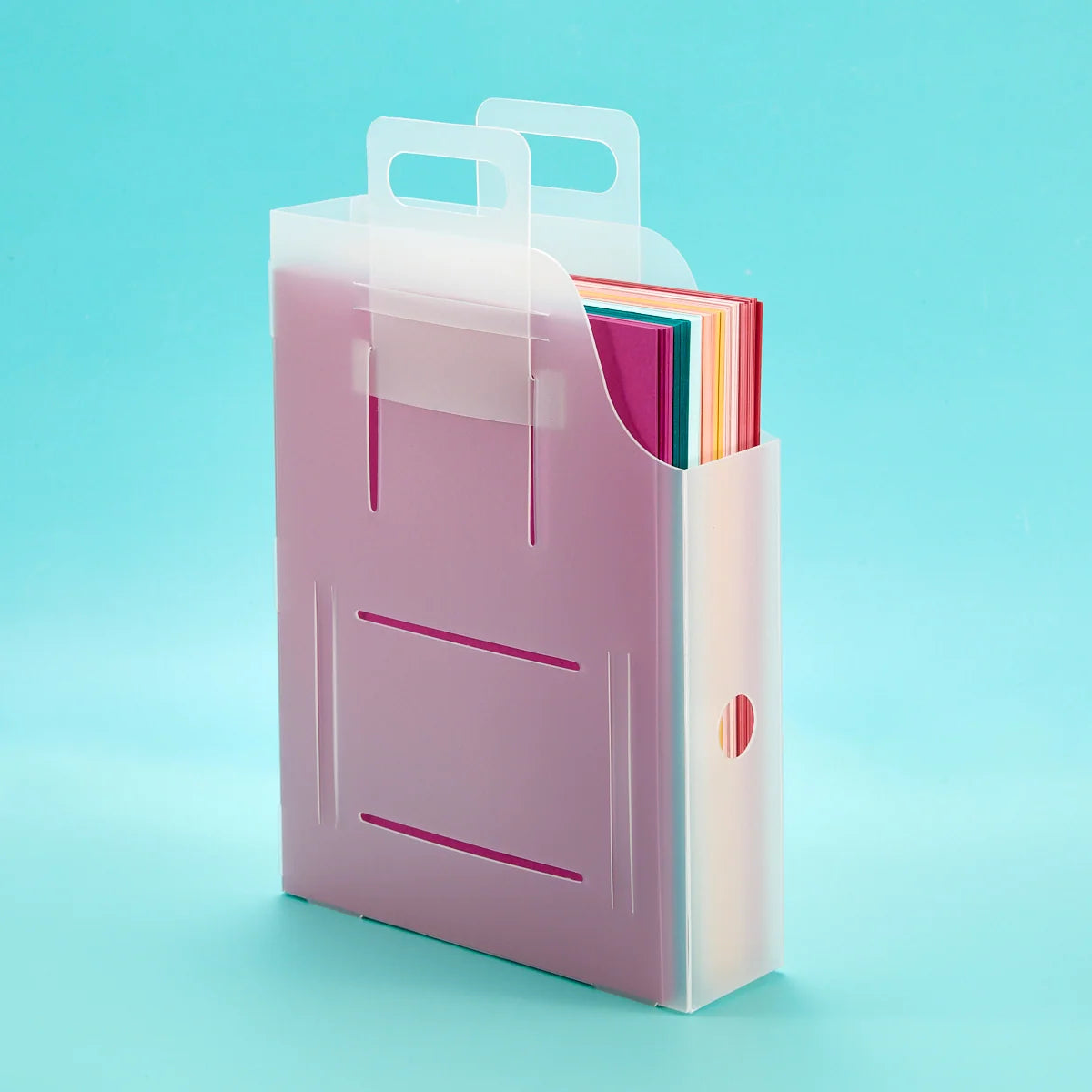 frosted container with handles and filled with colorful 8.5 x 11 paper inside on a light blue background