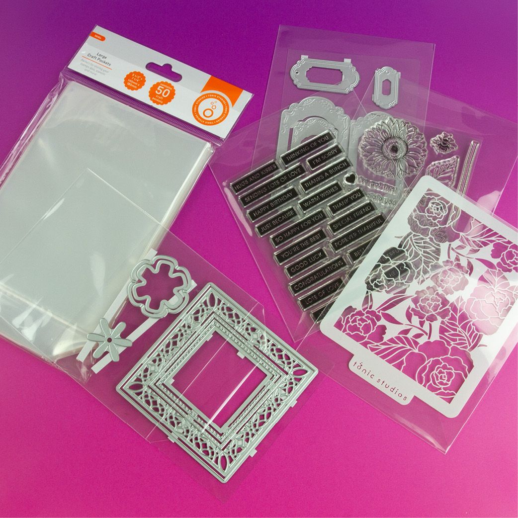 Clear craft packets in a package with a brand label on a purple background and dies and stamps