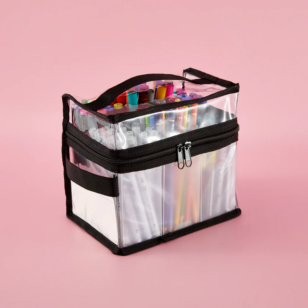 Clear storage bag with black zipper containing colorful markers on a pink background
