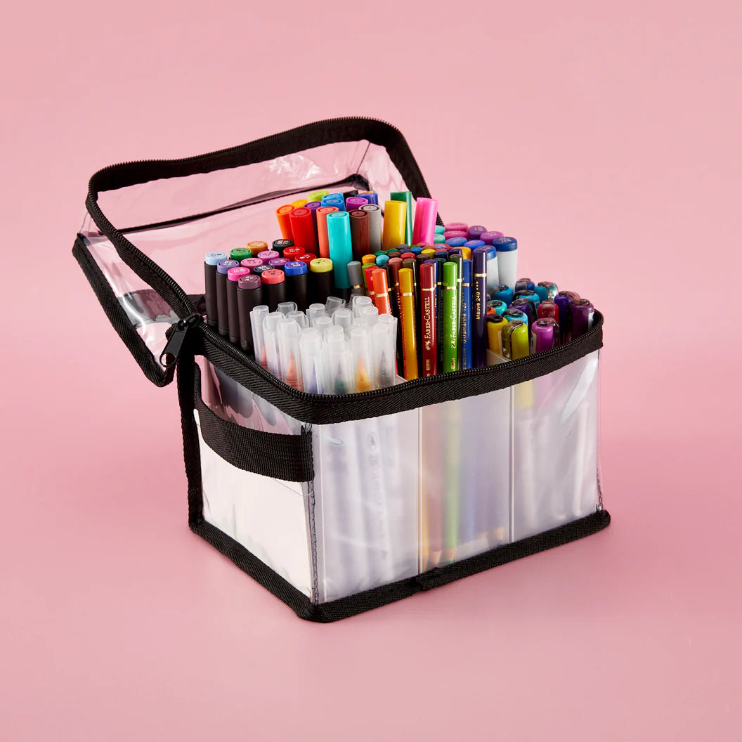 Clear craft carrying case with colorful markers and handle on a pink background