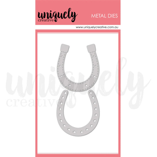 A package of uniquely creative metal dies featuring two horseshoe-shaped metal cutters, shown on a white background with a pink header card.