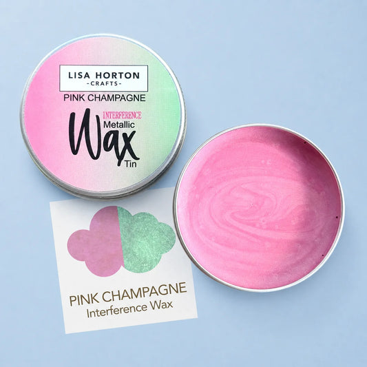 Lisa Horton Crafts Interference Wax Tin in Pink Champagne, showing the closed tin lid with a pink-to-green gradient label, the open tin with pink wax inside, and a small color card on a light blue background.